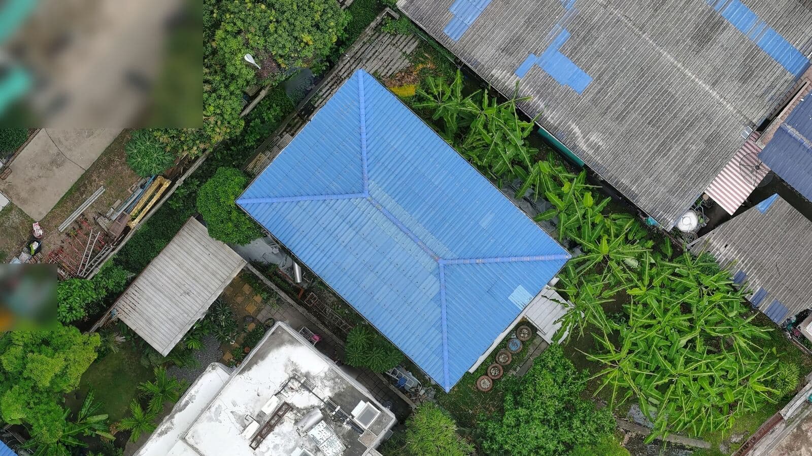 Aerial photo of one house and the roofs around it in Bang Kachao